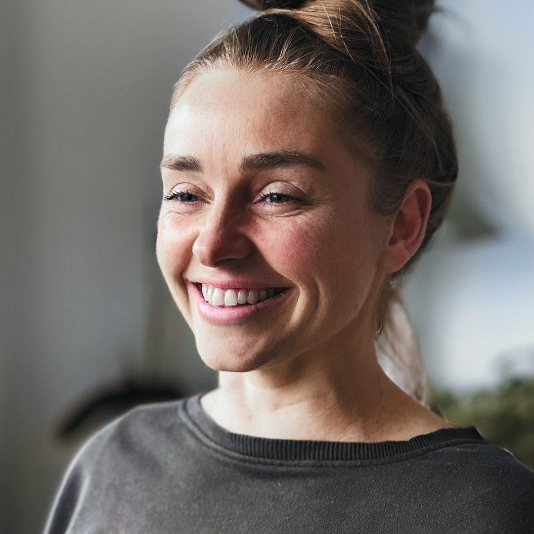 Portrait of Production Designer Anna Herold Pola standing with a confident expression, in an artistic setting.